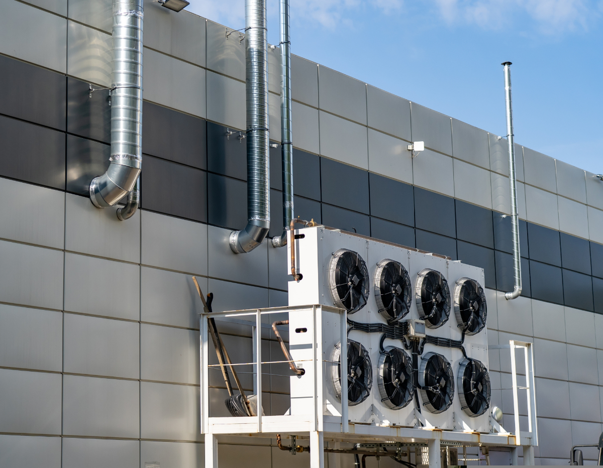 Large,Ventilation,Pipes,On,Facade,Of,Commercial,Building.,Outdoor,Split Large ventilation pipes on facade of commercial building. Outdoor split air conditioner units mounted on industrial building facade. Air conditioning system assembled on side of building